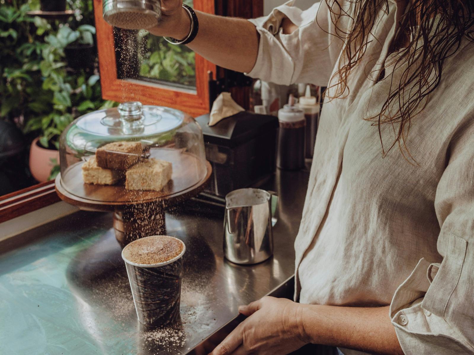 Lady dusting a coffee. Lady dusting a coffee.