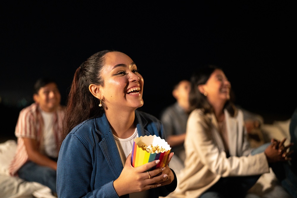 Young woman watching a movie. at the outdoor cinema Young woman watching a movie. at the outdoor cinema