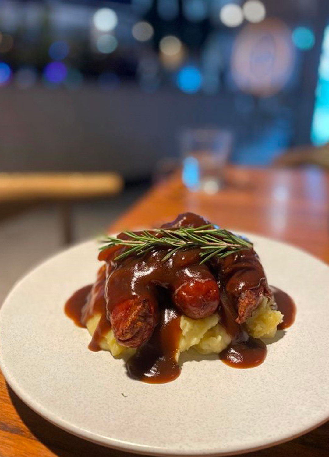 Sausages and gravy on mashed potato at Club Parkview Sausages and gravy on mashed potato at Club Parkview