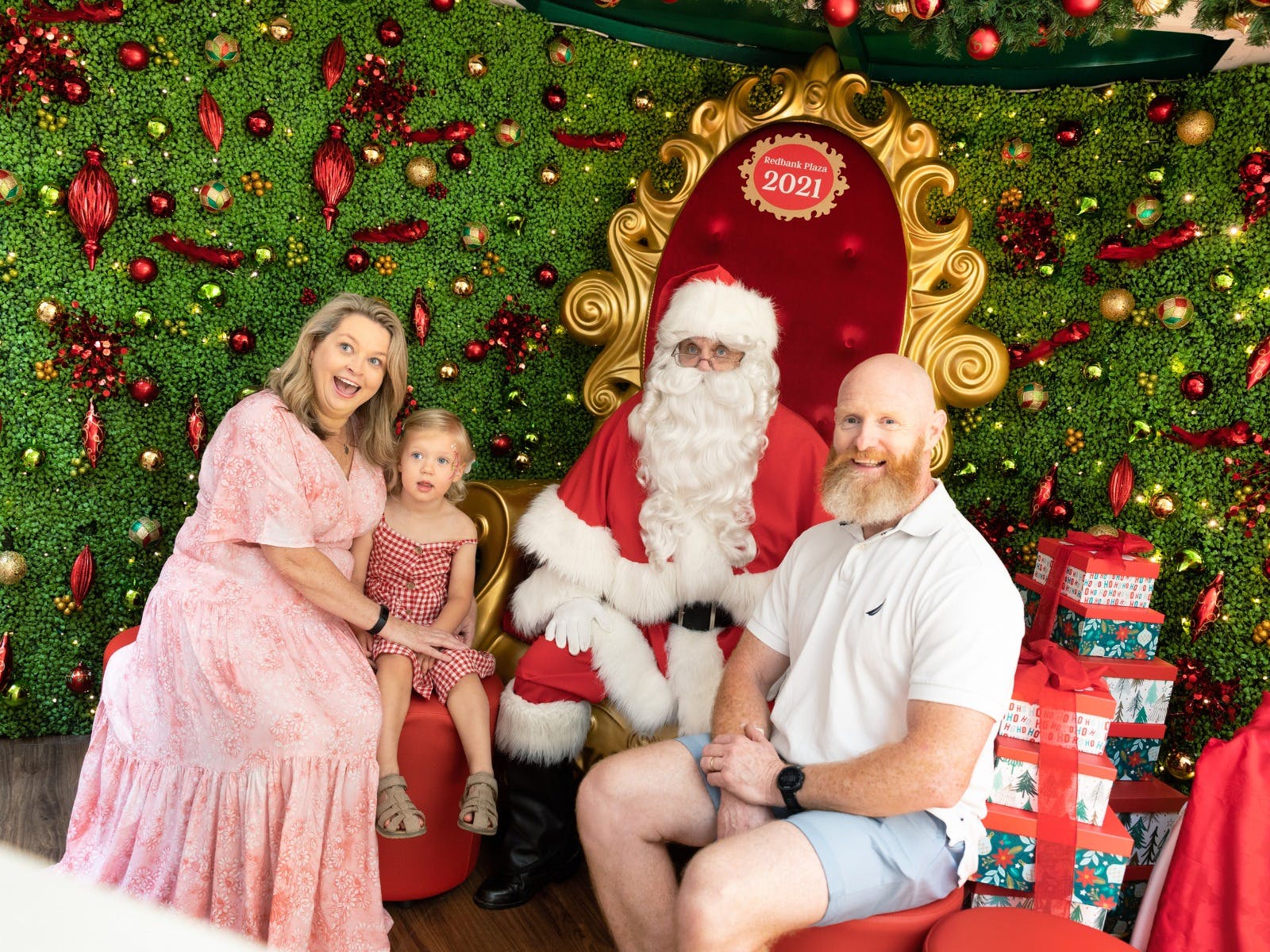 Family sitting down for photo with Santa